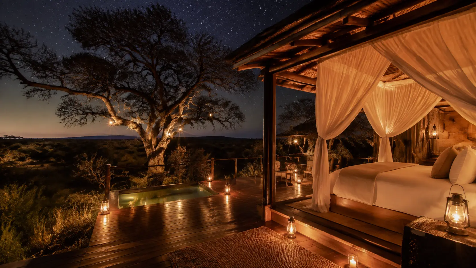 Lantern-lit lodge suite and plunge pool deck open to the bushveld under a star-filled sky